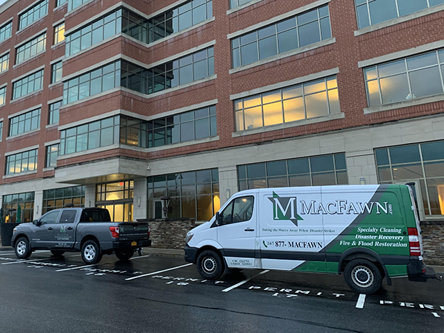 Truck and van outside of building for sanitizing