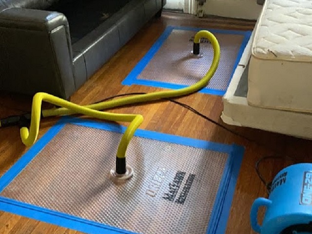 Rescue mats in use to save hardwood floors after water damage